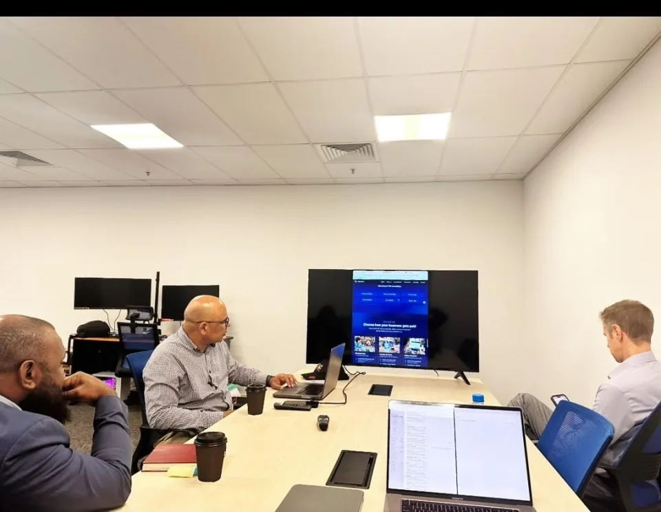 A website review meeting in the Pay It Now PNG office